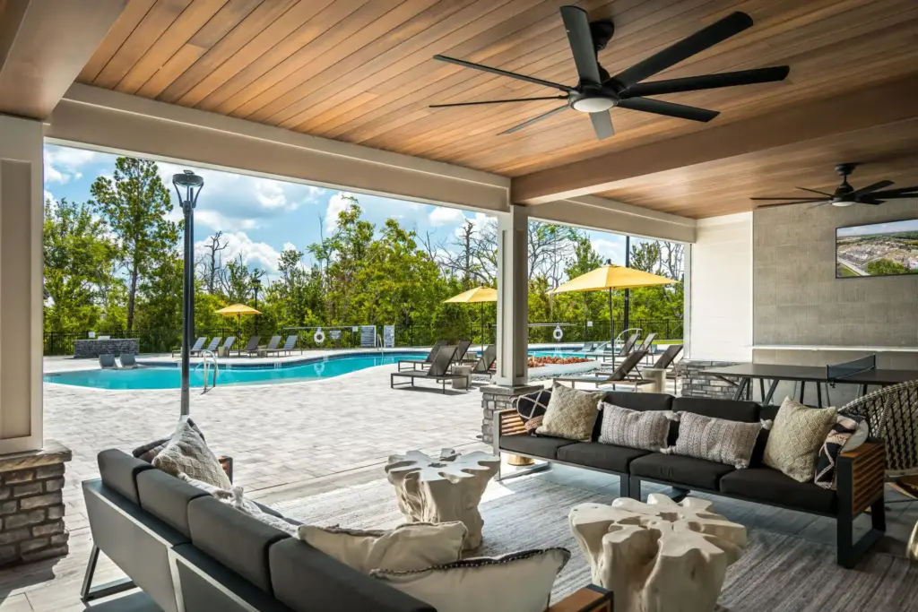 Lanai with modern furniture, fans, and TV